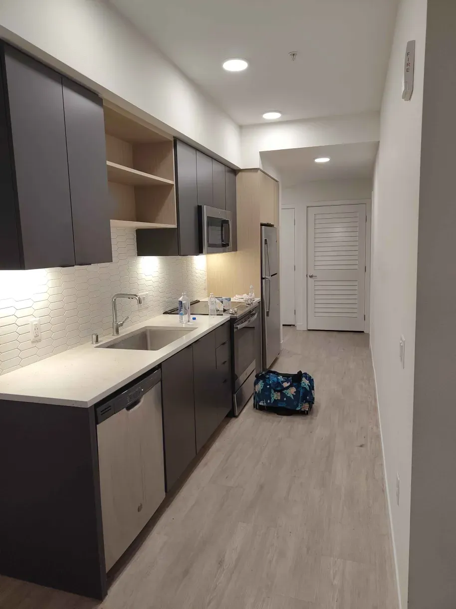 A picture of our Washington apartment's hallway/kitchen, which connects the bathroom, entryway, and living room.